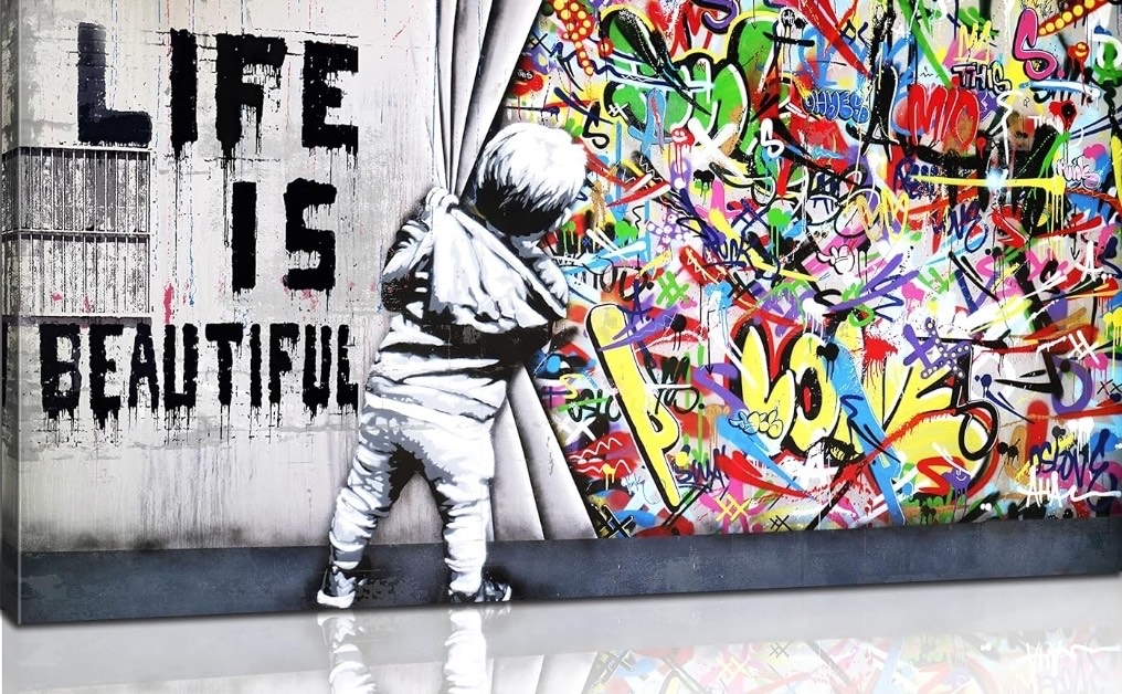 Black-and-white figure beside a vivid graffiti wall